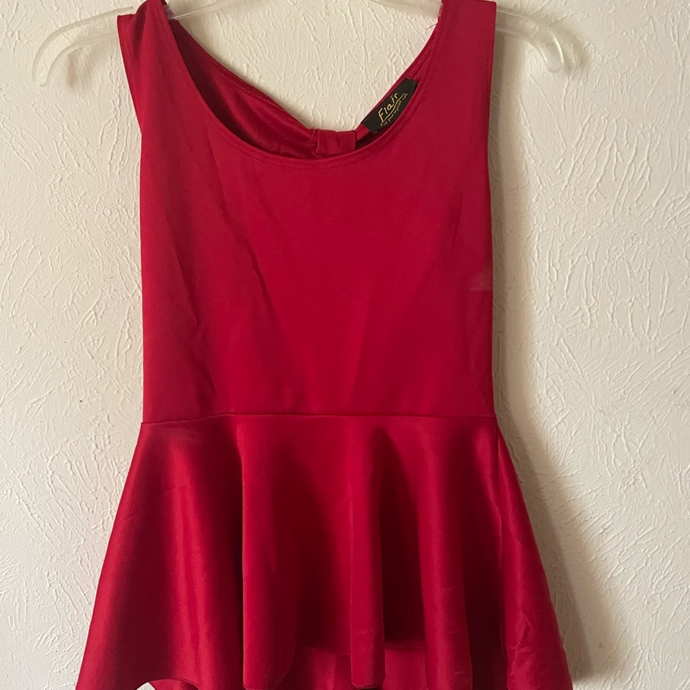Sleeveless red peplum top with bow back